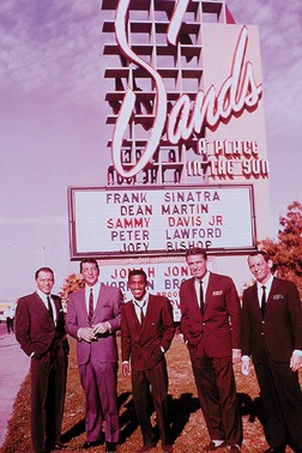 Frank Sinatra, Dean Martin, Sammy Davis Jr., Peter Lawford, and Joey Bishop in front of the Sands Hotel marquee